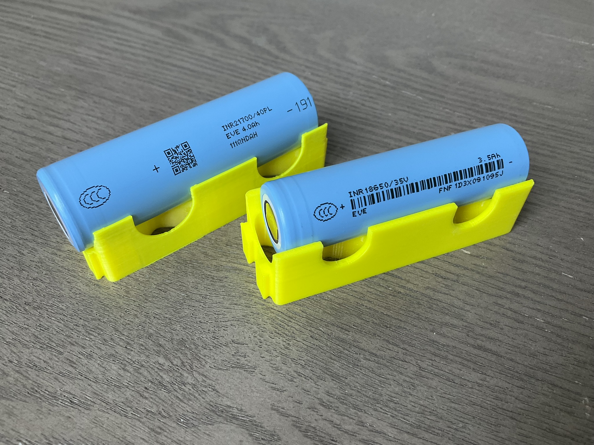 A pair of 18650 lithium-ion cells (left), shown next to a larger 21700 (right) for scale. The PicoCalc uses two 18650 cells.