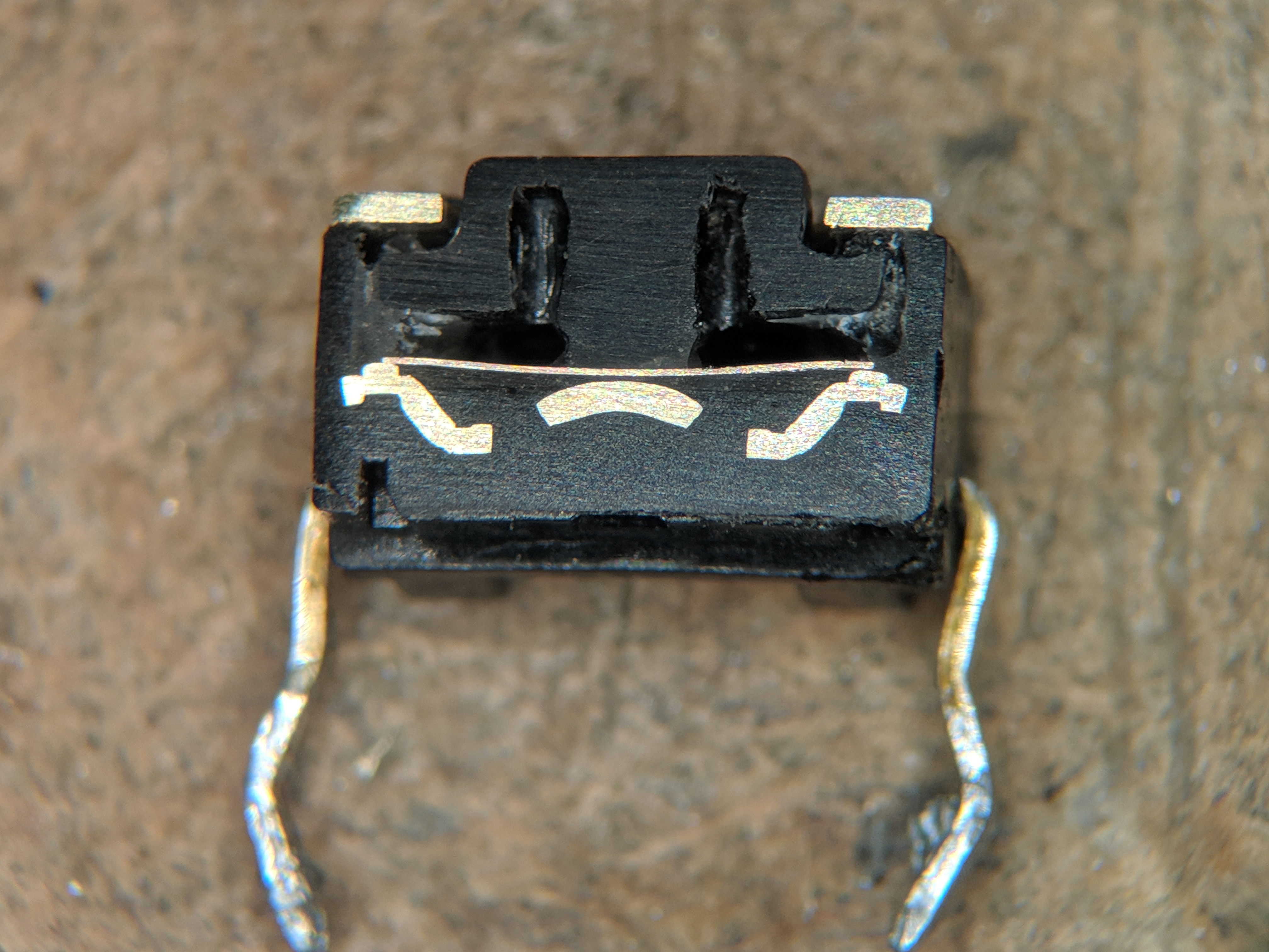 Cross-section of a 6 × 6 mm tact (tactile) switch — the canonical button used for the D-pad and face-button mod below. The metallic dome under the plastic actuator is what gives the click feel; it …