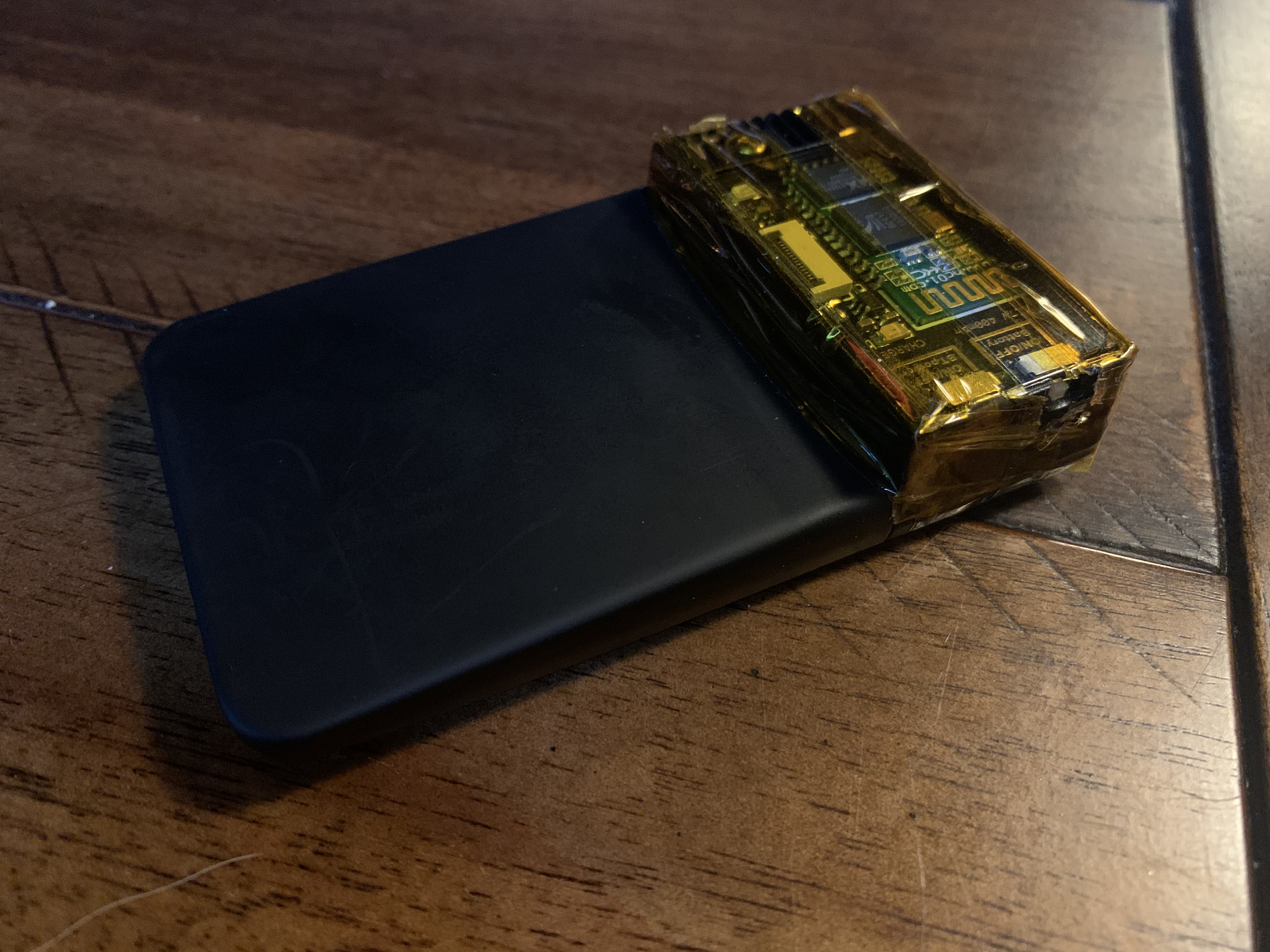 A Proxmark3 RDV4 with the Bluetooth + battery accessory module attached — the canonical field-research configuration for the Proxmark3. The RDV4's design accommodates a daughterboard expansion bus …