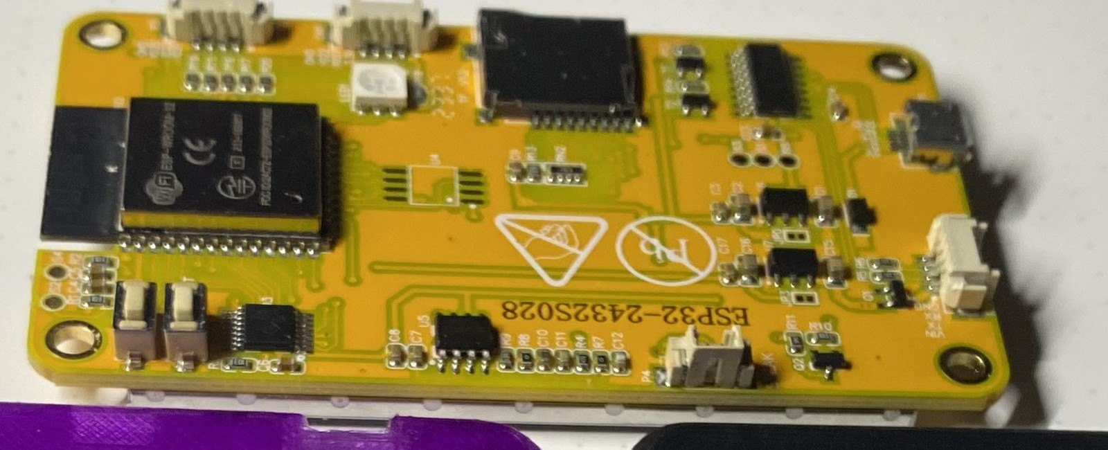 Figure 2 — Close-up of the board's underside: the JST connectors, the microSD slot and the ESP32 module, with the ESP32-2432S028 marking. Image: crop of a photo by Mechaela, witnessmenow/ESP32-Ch…
