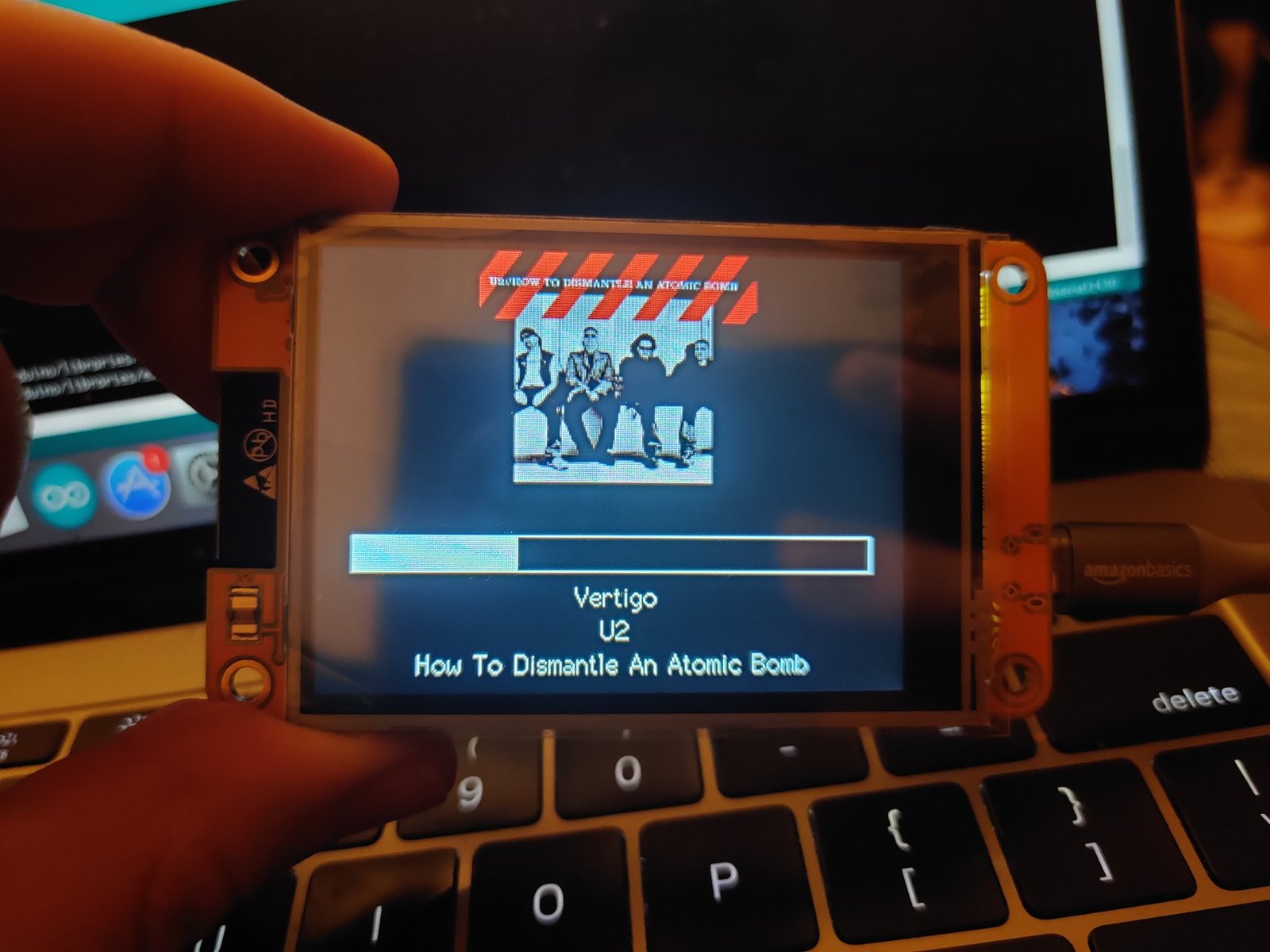 Figure 4 — A 2.8" CYD with its display lit, running a demo sketch; SquachWatch draws to this same 320×240 panel. Image: Brian Lough, witnessmenow/ESP32-Cheap-Yellow-Display README.